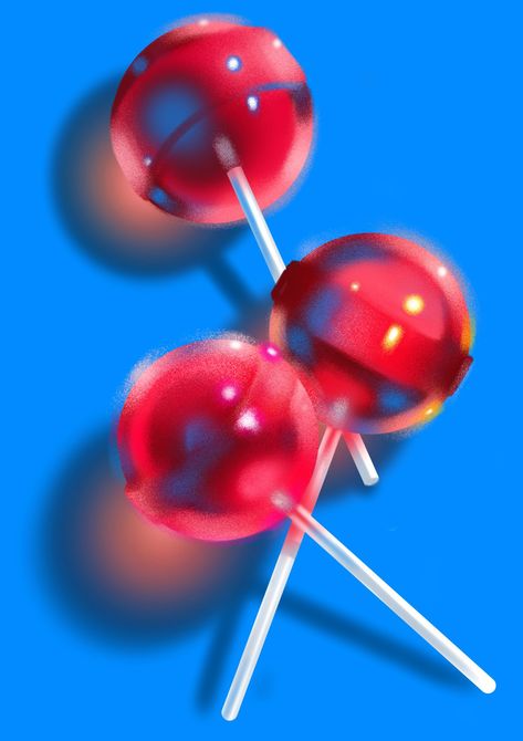Glossy red lollipops against a vivid blue background